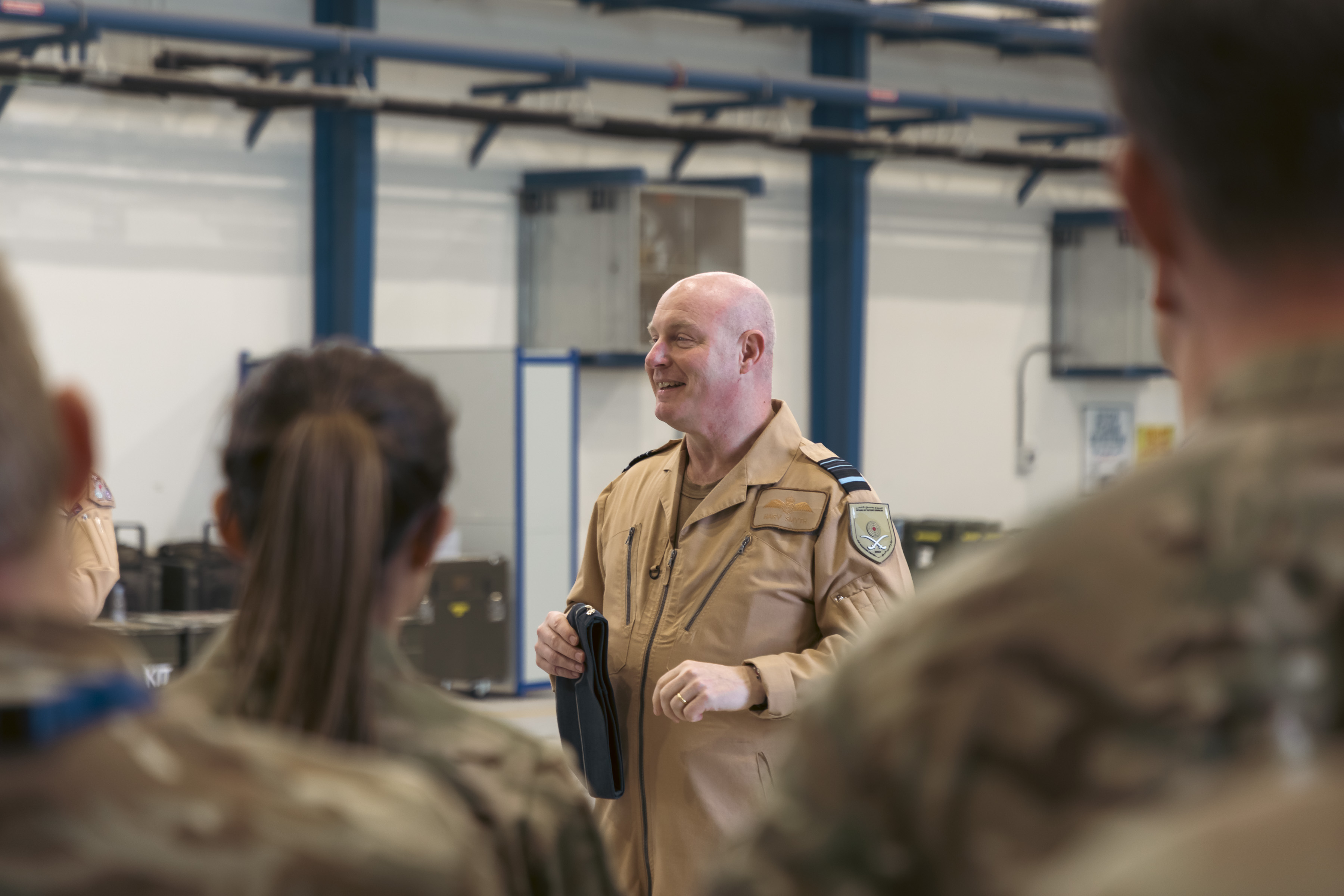 Image shows RAF aviators inside a hangar.